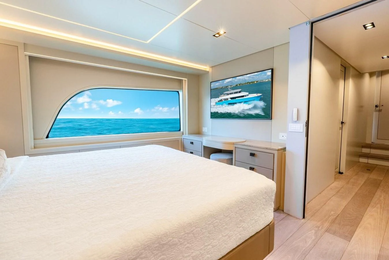 A spacious stateroom with a large bed and a scenic ocean view through the window. aboard LADY SADIE Yacht for Sale