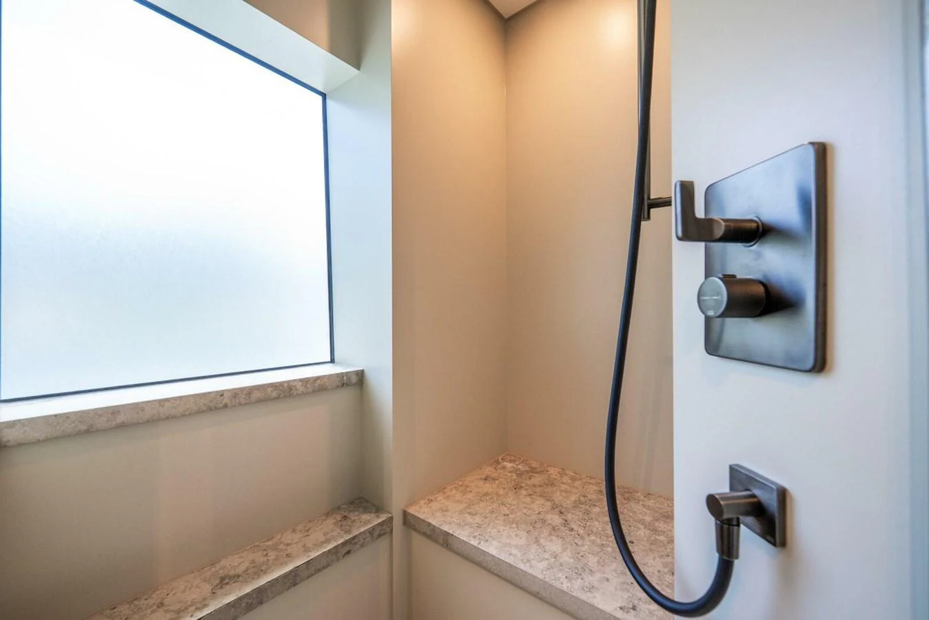 A modern yacht bathroom with sleek fixtures and a frosted window. aboard LADY SADIE Yacht for Sale