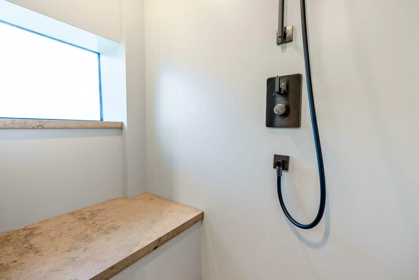 A clean and modern shower area with a window providing natural light. aboard LADY SADIE Yacht for Sale