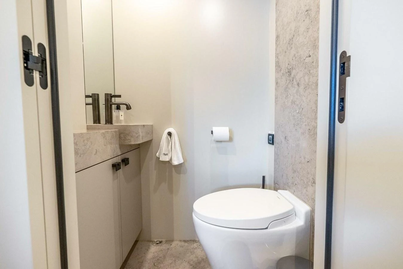 A modern yacht bathroom featuring a sleek toilet and vanity area. aboard LADY SADIE Yacht for Sale