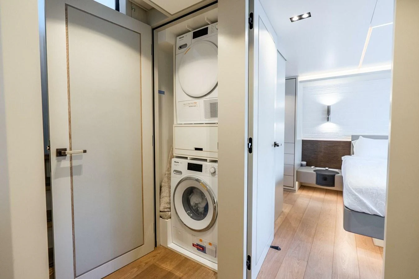 The yacht features a convenient laundry area with a stacked washer and dryer. aboard LADY SADIE Yacht for Sale