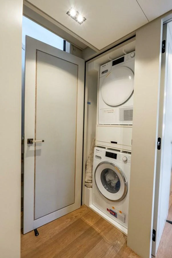 The yacht features a compact and efficient laundry room with modern appliances. aboard LADY SADIE Yacht for Sale
