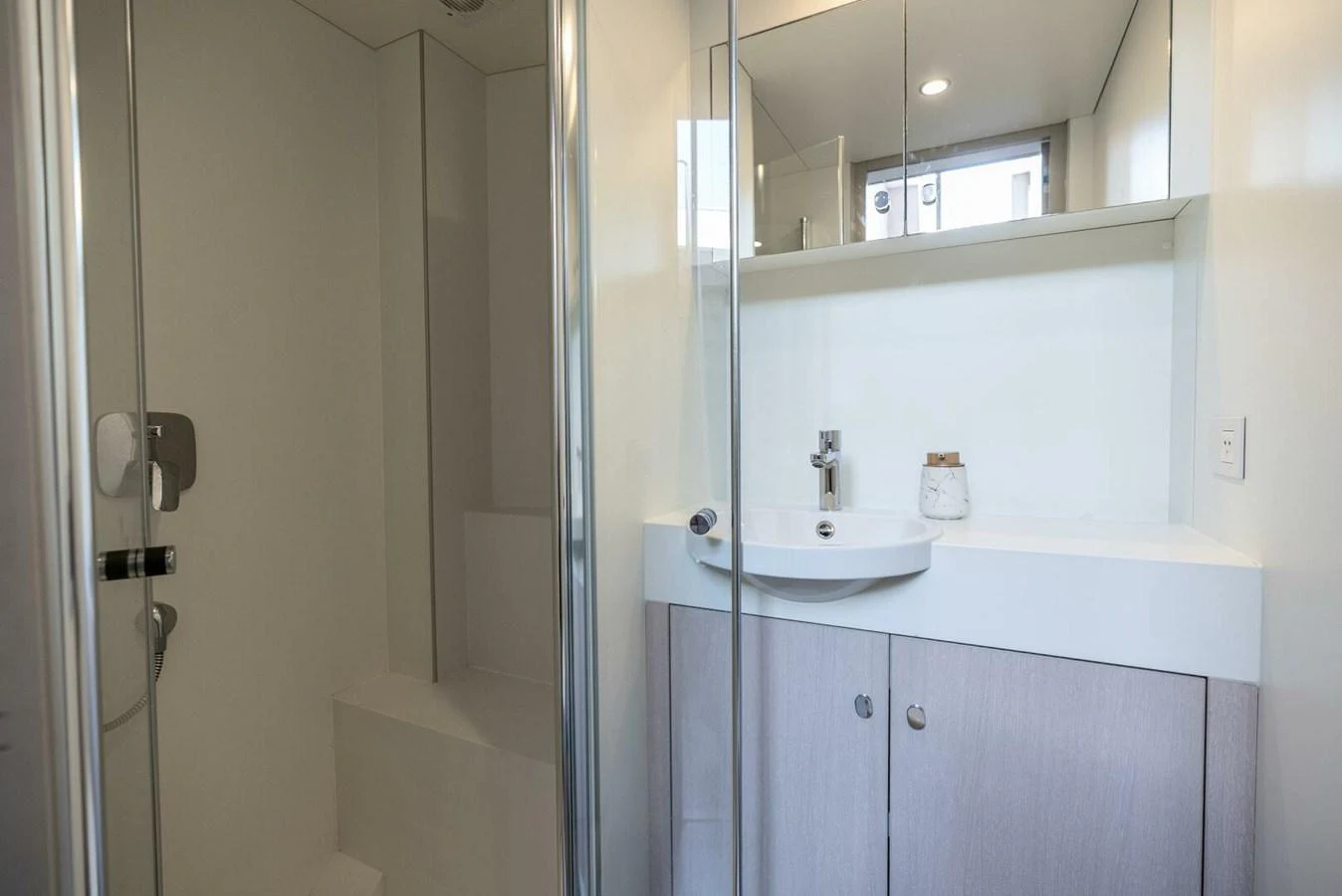 A modern yacht bathroom featuring a sleek shower and vanity area. aboard LADY SADIE Yacht for Sale