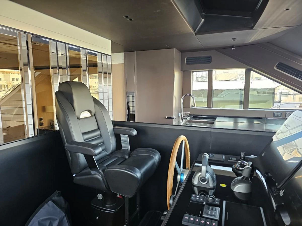 The helm station features a sleek design with modern controls and a comfortable captain's chair. aboard YAS 88 Yacht for Sale
