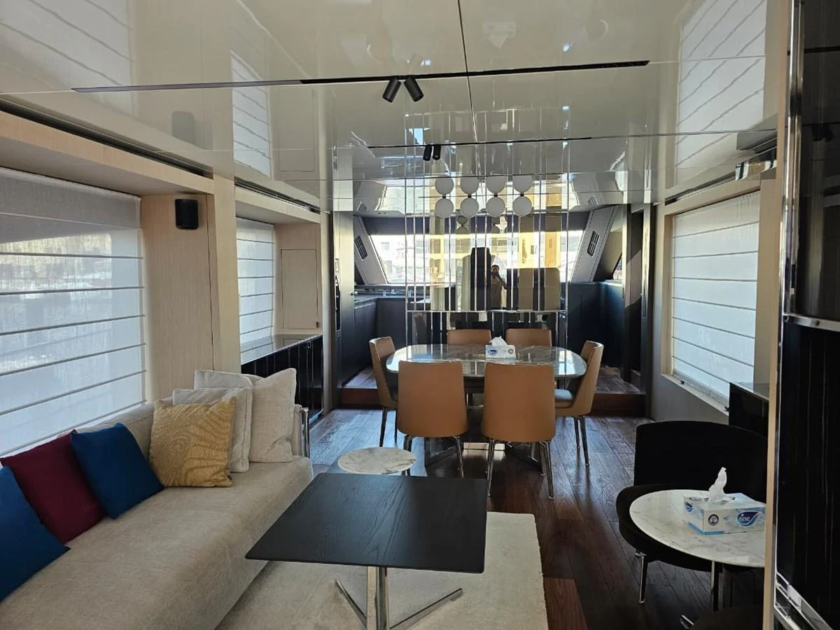 The yacht's salon features a comfortable seating area with a modern dining space, exuding elegance and style. aboard YAS 88 Yacht for Sale