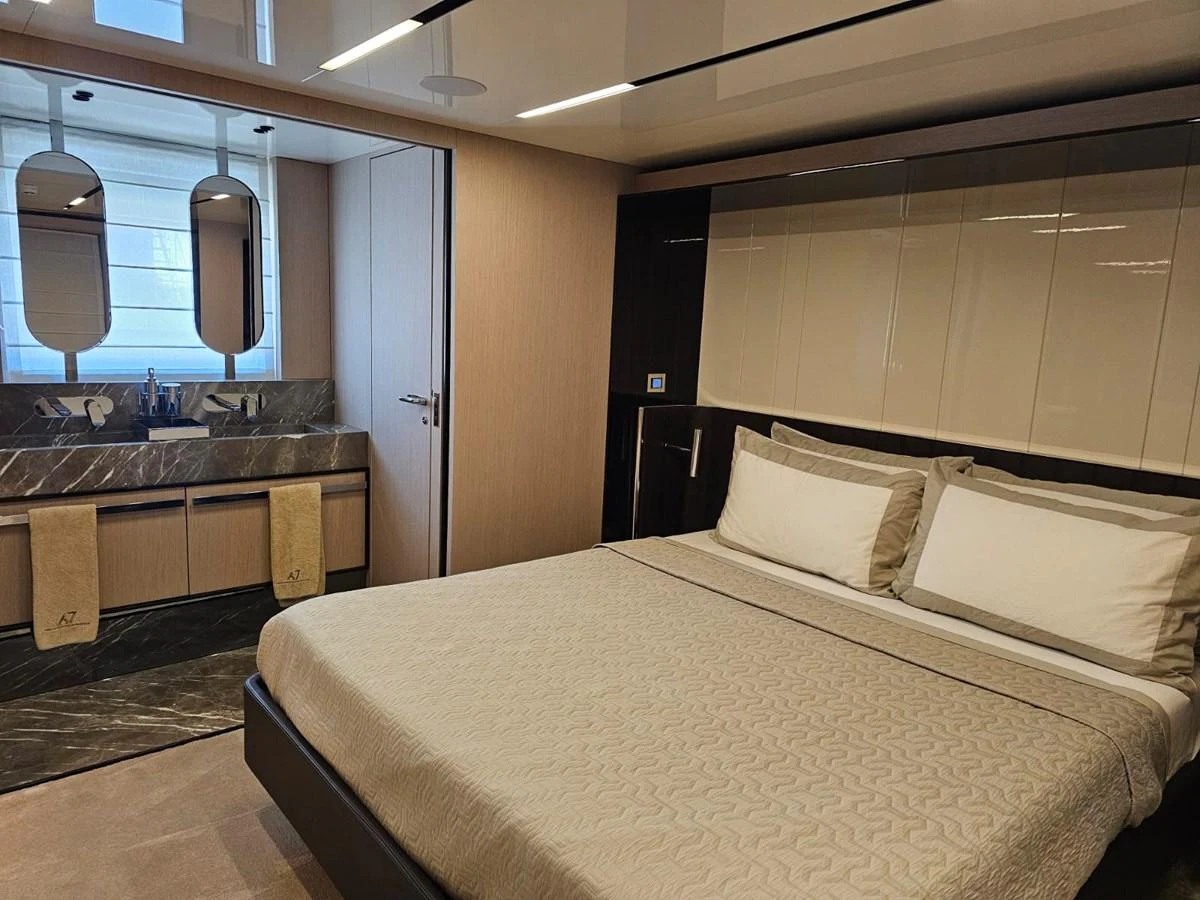 The stateroom features a luxurious bed with elegant linens and an ensuite bathroom with modern fixtures. aboard YAS 88 Yacht for Sale