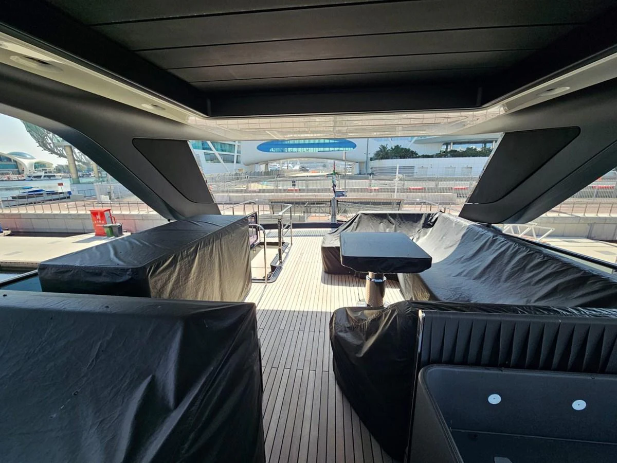 The aft deck features covered seating and dining areas, providing a comfortable space for relaxation. aboard YAS 88 Yacht for Sale