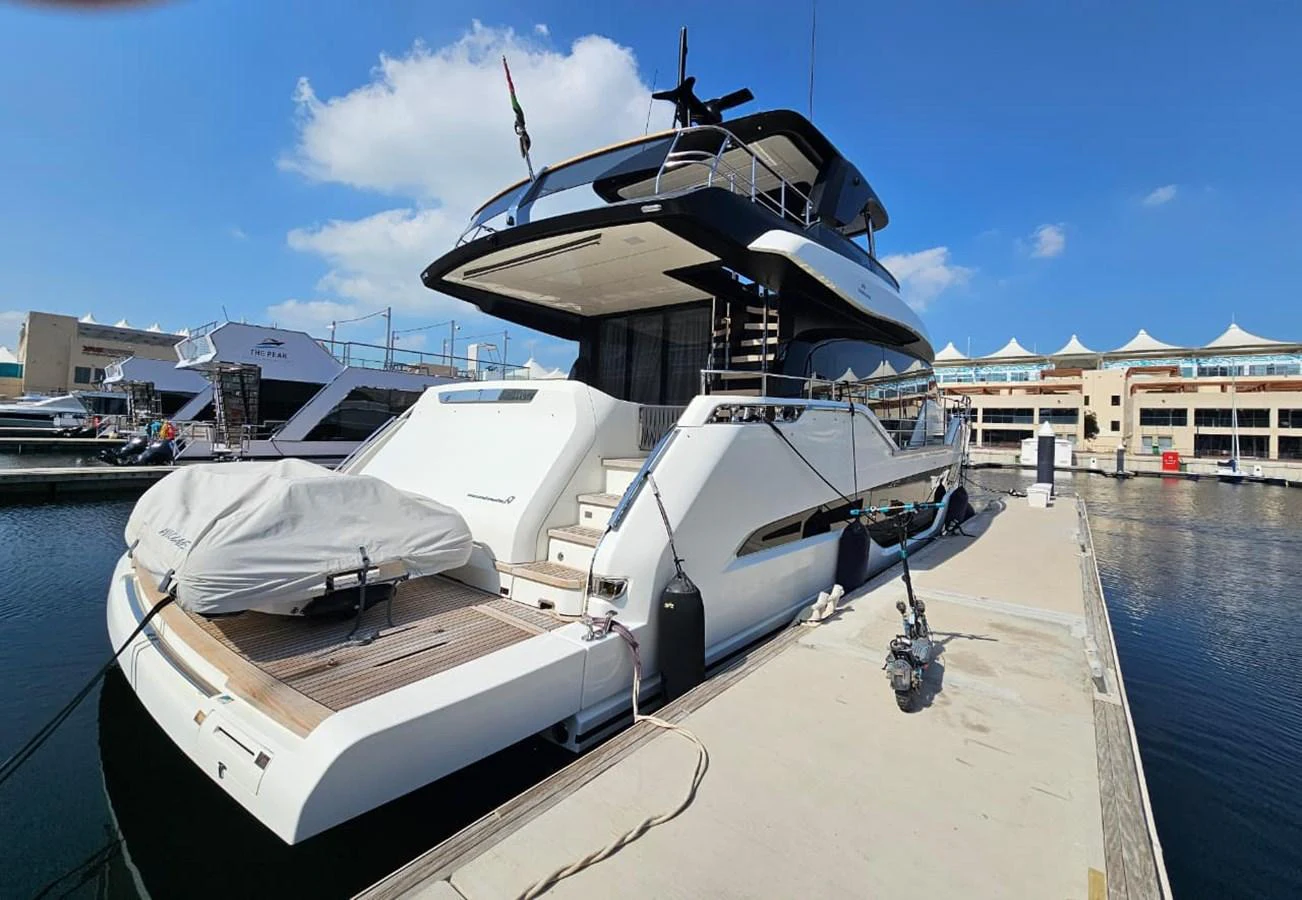 A sleek yacht is docked at a marina under a bright blue sky. aboard YAS 88 Yacht for Sale