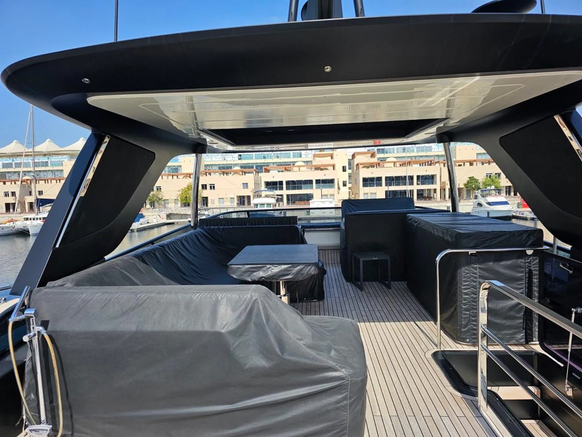 The flybridge features ample seating and a table under a sleek canopy. aboard YAS 88 Yacht for Sale