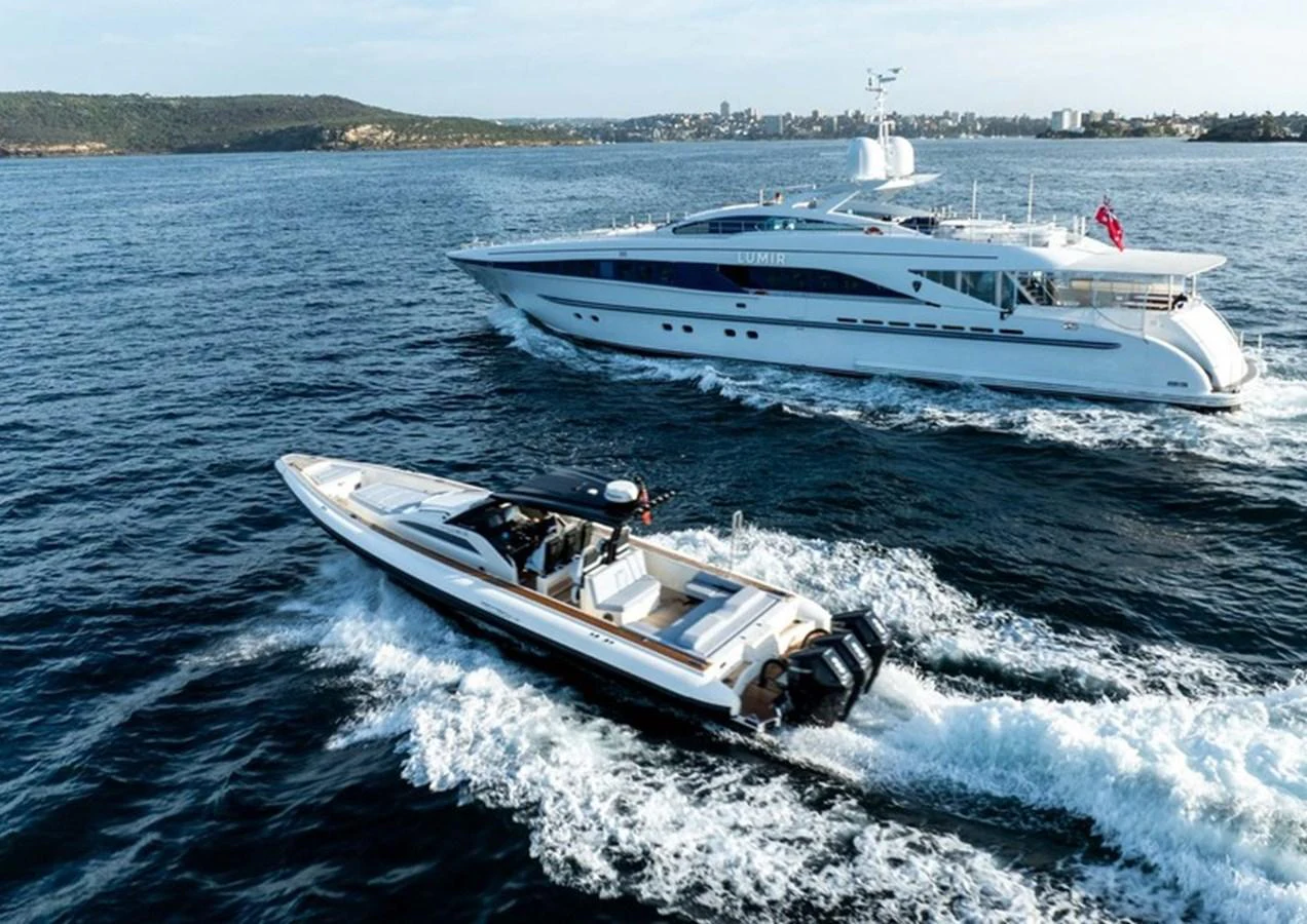 A sleek yacht cruises through the water accompanied by a fast tender boat. aboard LUMIR Yacht for Sale