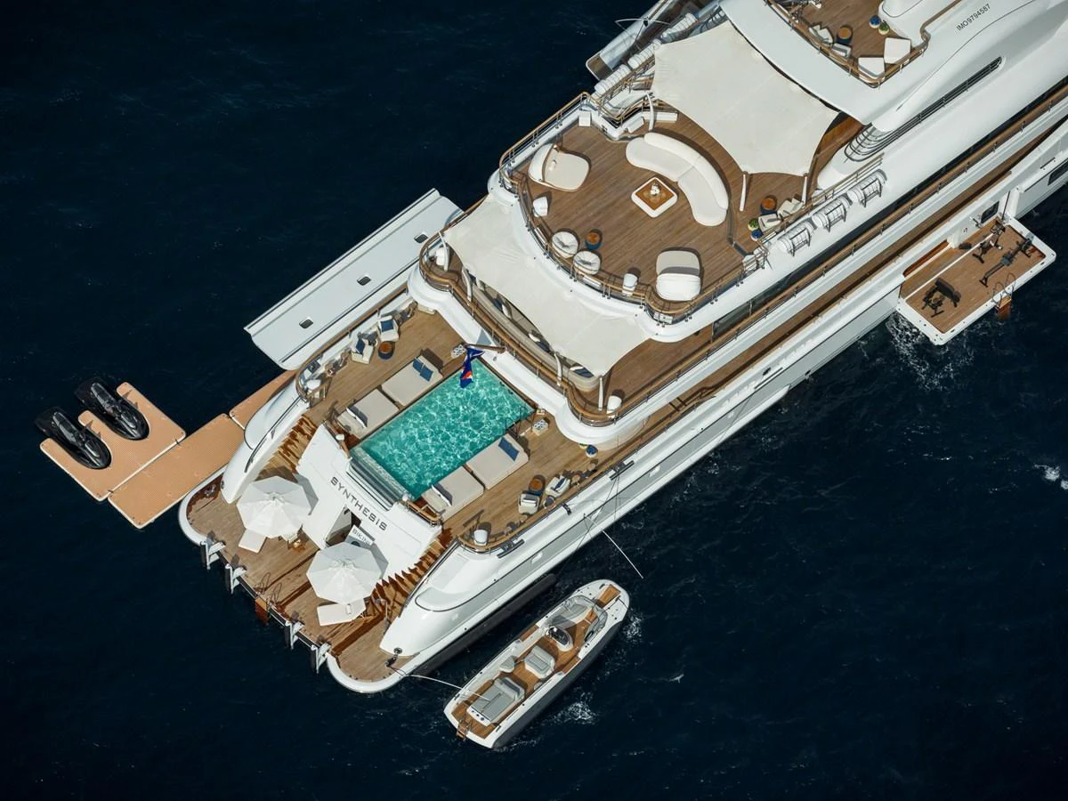 The yacht's aft deck features a luxurious pool and ample lounging areas for relaxation. aboard SYNTHESIS Yacht for Sale