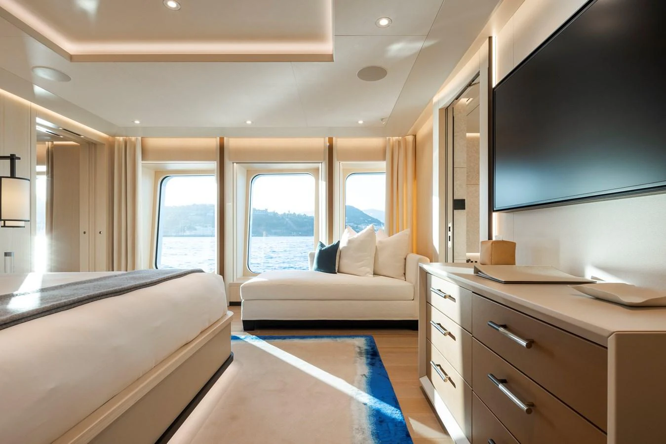 A luxurious stateroom with large windows offering stunning ocean views. aboard SYNTHESIS Yacht for Sale