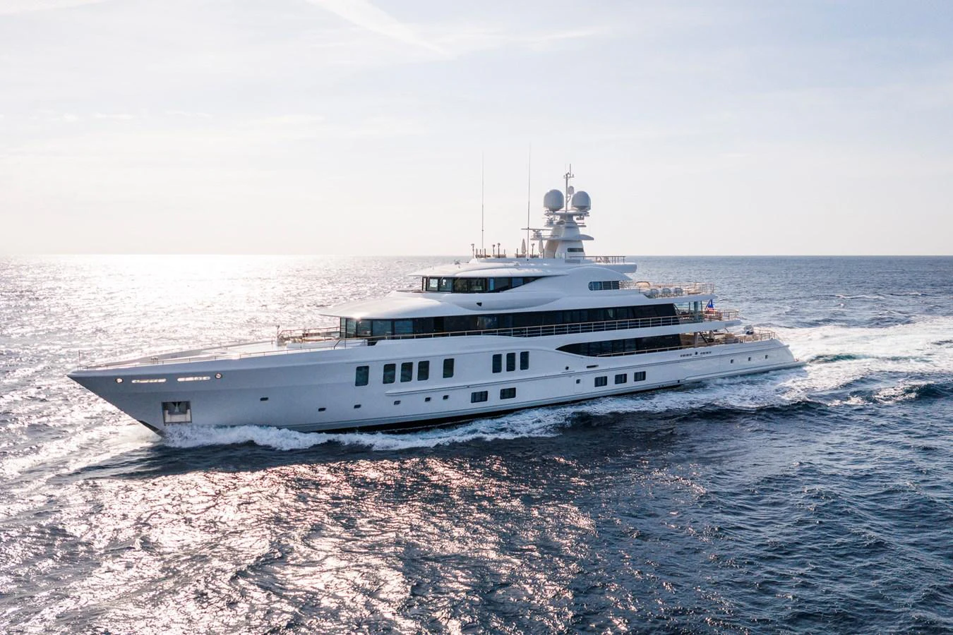 A sleek and modern yacht cruises gracefully on the open sea under a clear sky. aboard SYNTHESIS Yacht for Sale