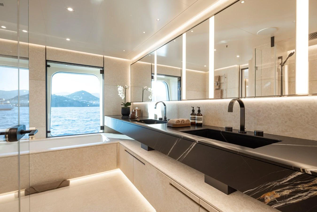 The yacht's bathroom features modern fixtures and a stunning view through large windows. aboard SYNTHESIS Yacht for Sale