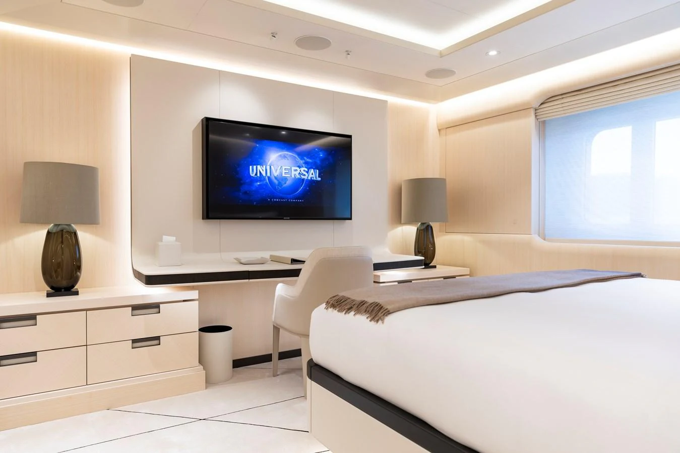 The stateroom features a modern design with a large bed, a flat-screen TV, and elegant furnishings. aboard SYNTHESIS Yacht for Sale