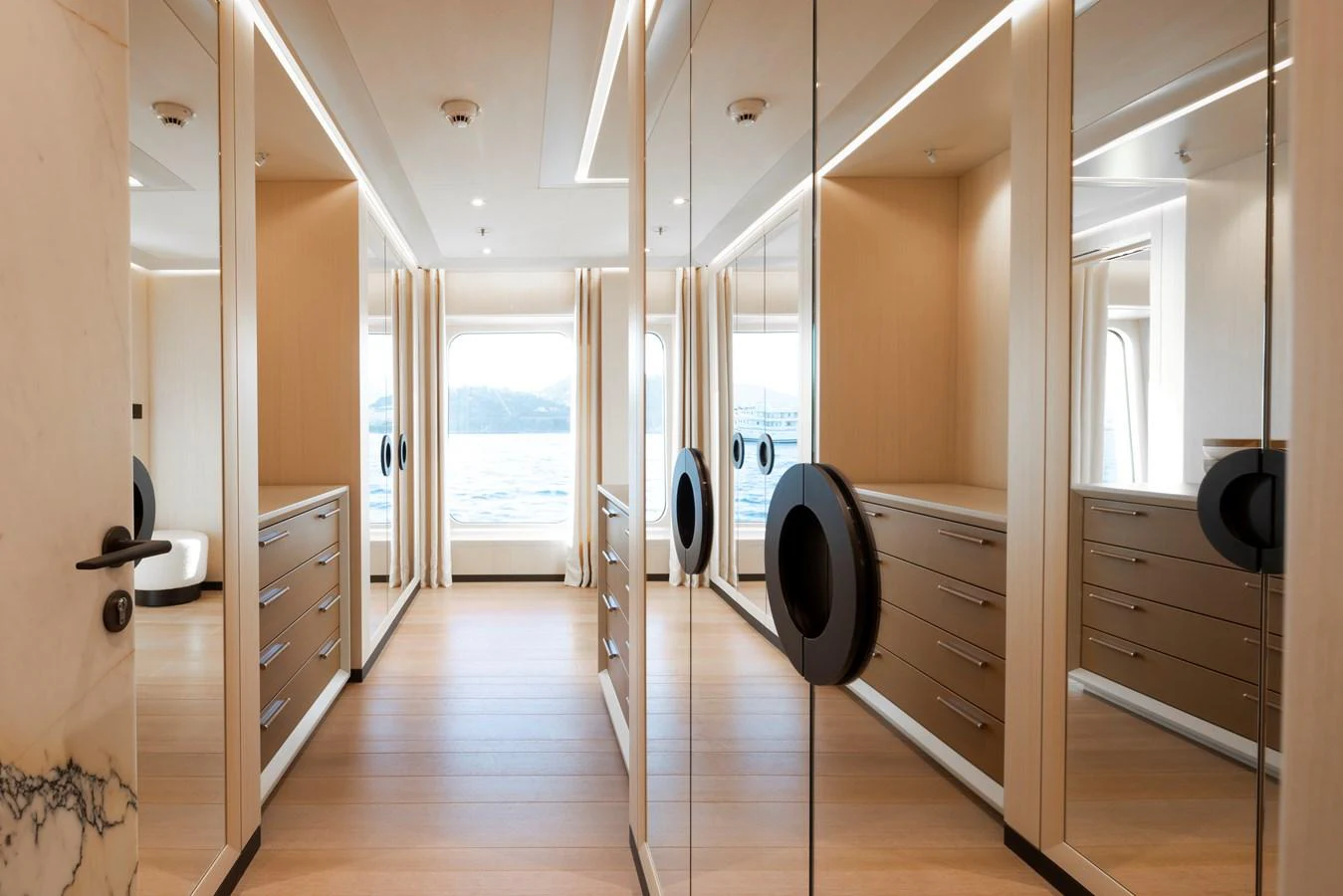 The yacht features a spacious and elegant walk-in closet with ample storage and natural light. aboard SYNTHESIS Yacht for Sale