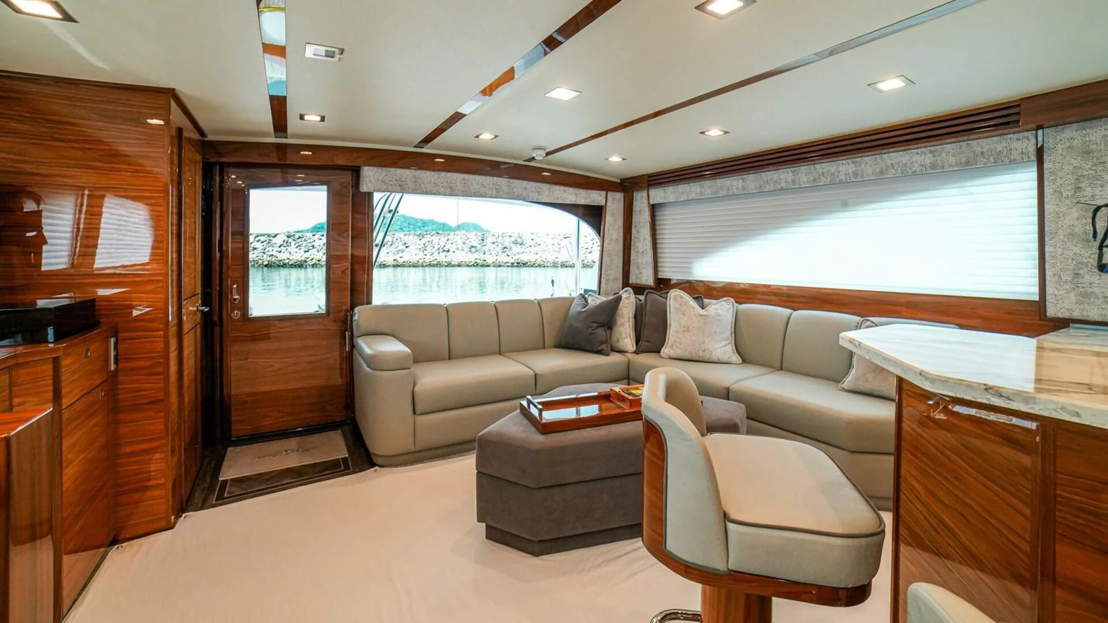 The yacht's salon features luxurious seating and elegant wood finishes. aboard FREE SPOOL Yacht for Sale