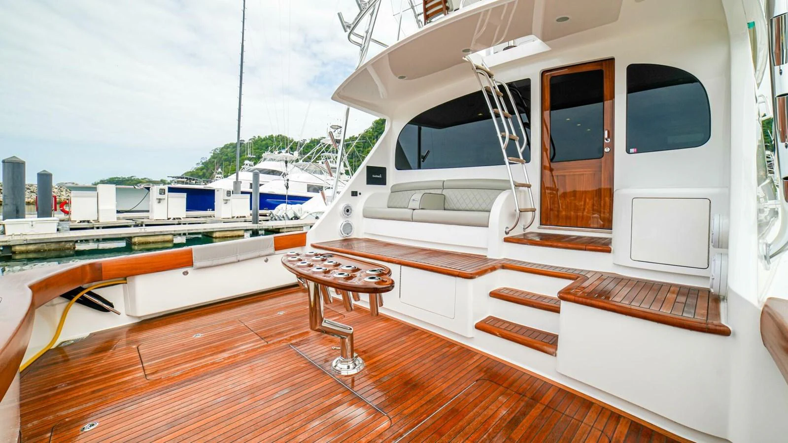 The aft deck features spacious seating and a polished wooden floor, perfect for relaxation and socializing. aboard FREE SPOOL Yacht for Sale