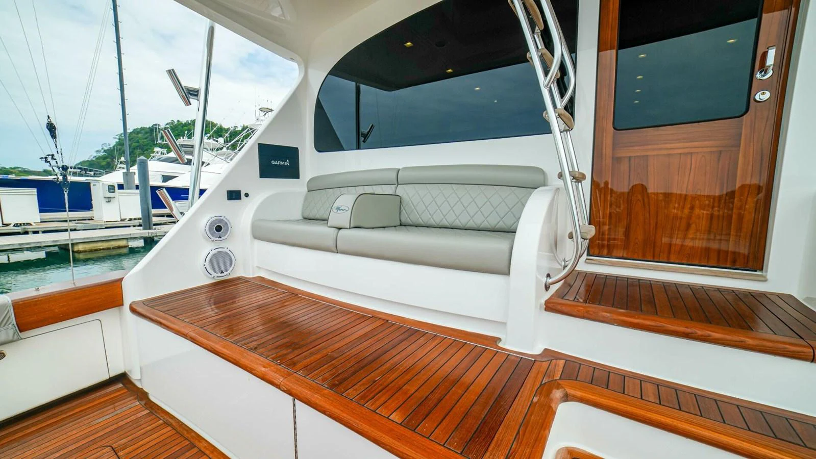 The aft deck features comfortable seating and elegant wooden flooring, perfect for relaxing outdoors. aboard FREE SPOOL Yacht for Sale