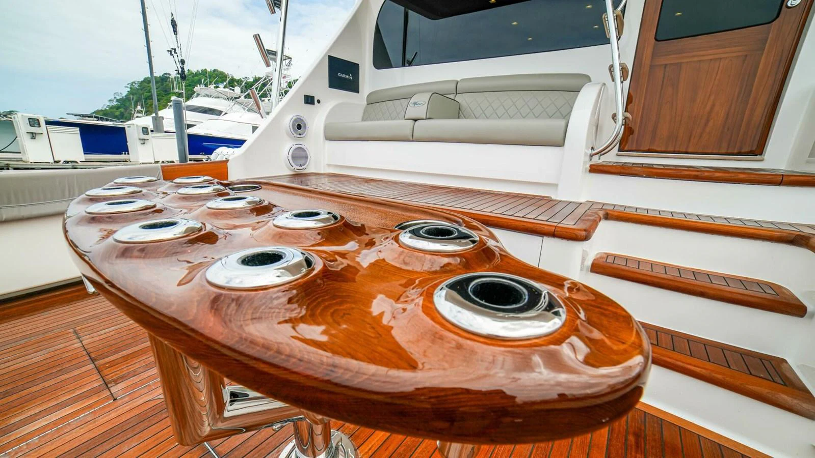 The image showcases a polished wooden table with multiple cup holders on the yacht's deck. aboard FREE SPOOL Yacht for Sale