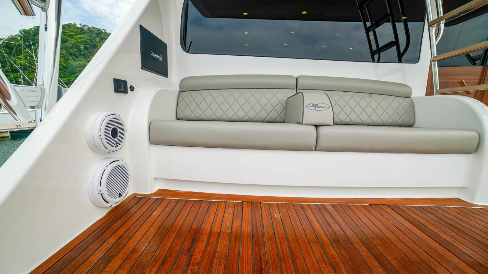 The aft deck features comfortable seating and high-quality speakers for entertainment. aboard FREE SPOOL Yacht for Sale