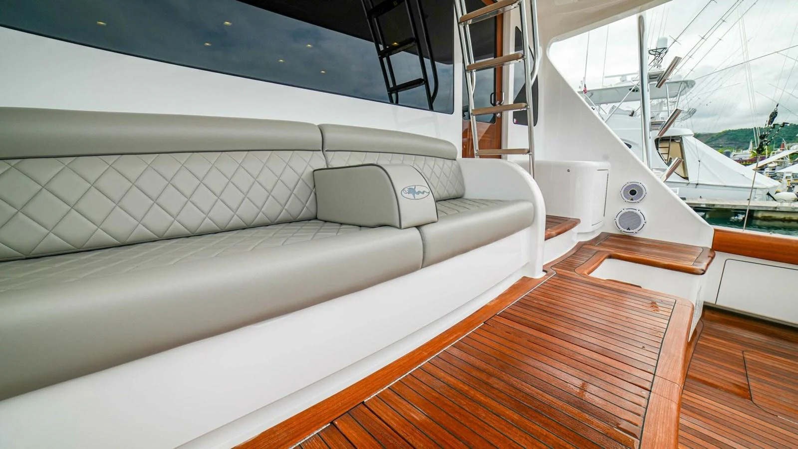 The aft deck features a comfortable seating area with elegant upholstery and wooden flooring. aboard FREE SPOOL Yacht for Sale
