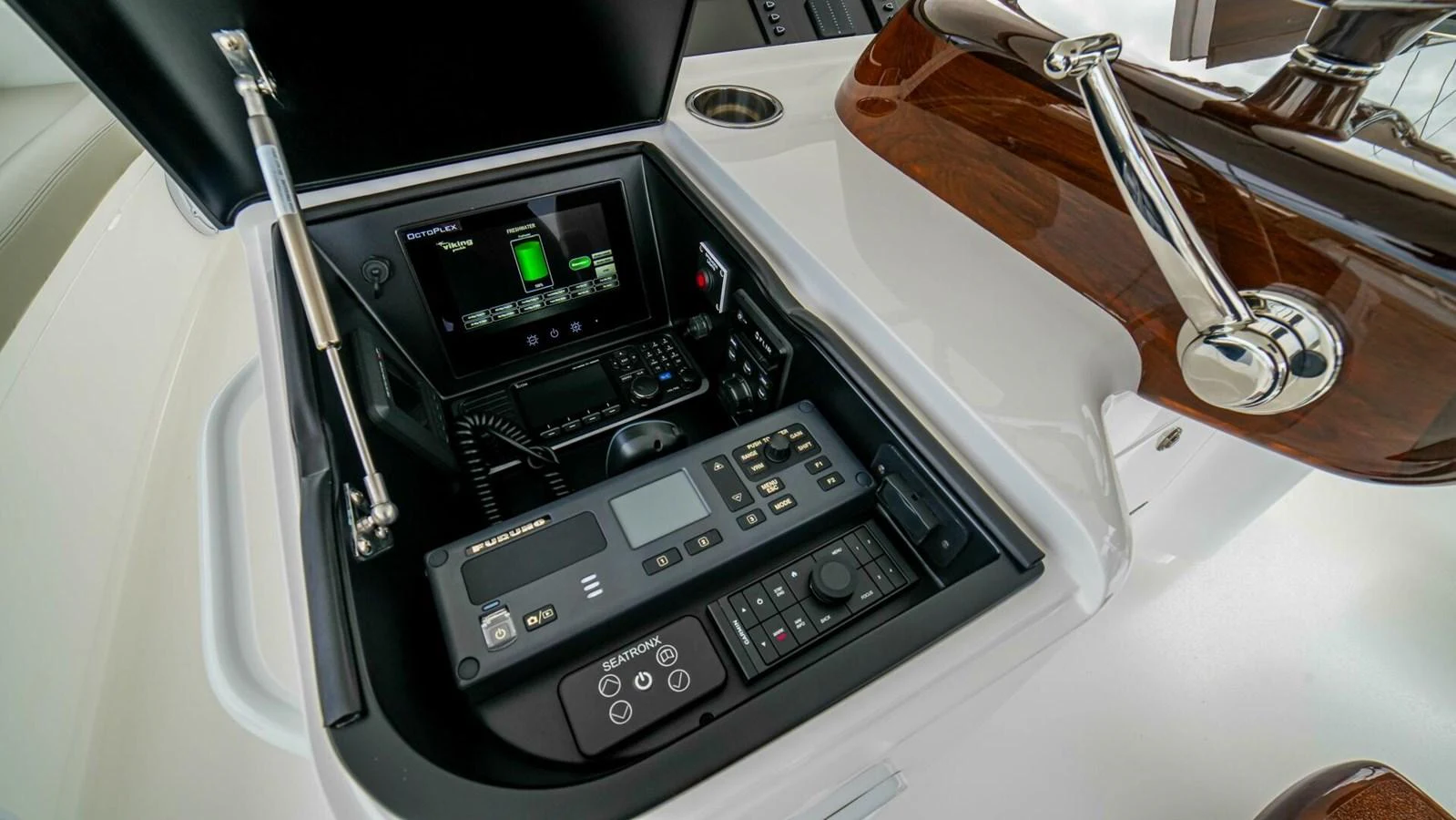 A close-up view of the yacht's helm control panel showcasing advanced navigation equipment. aboard FREE SPOOL Yacht for Sale