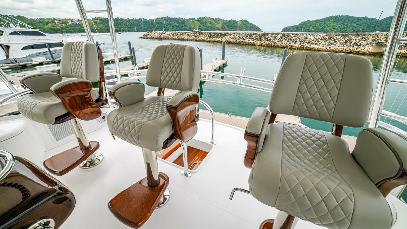 The helm area features comfortable, quilted seats with a view of the marina. aboard FREE SPOOL Yacht for Sale