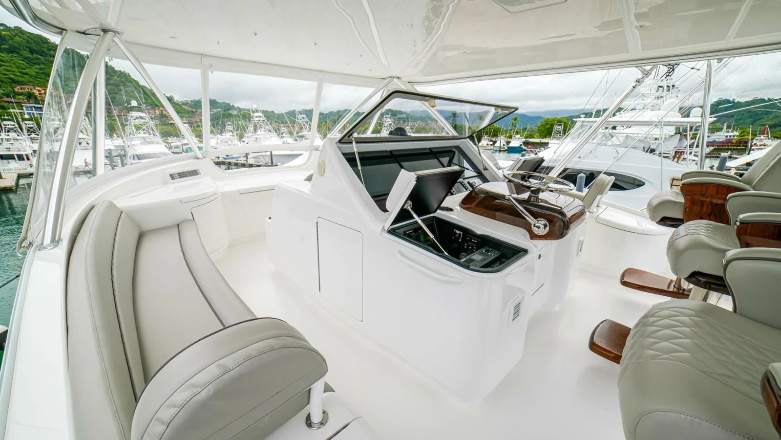 The helm area features comfortable seating and advanced navigation equipment. aboard FREE SPOOL Yacht for Sale
