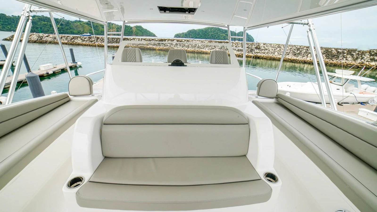The flybridge offers comfortable seating with a scenic view of the marina. aboard FREE SPOOL Yacht for Sale