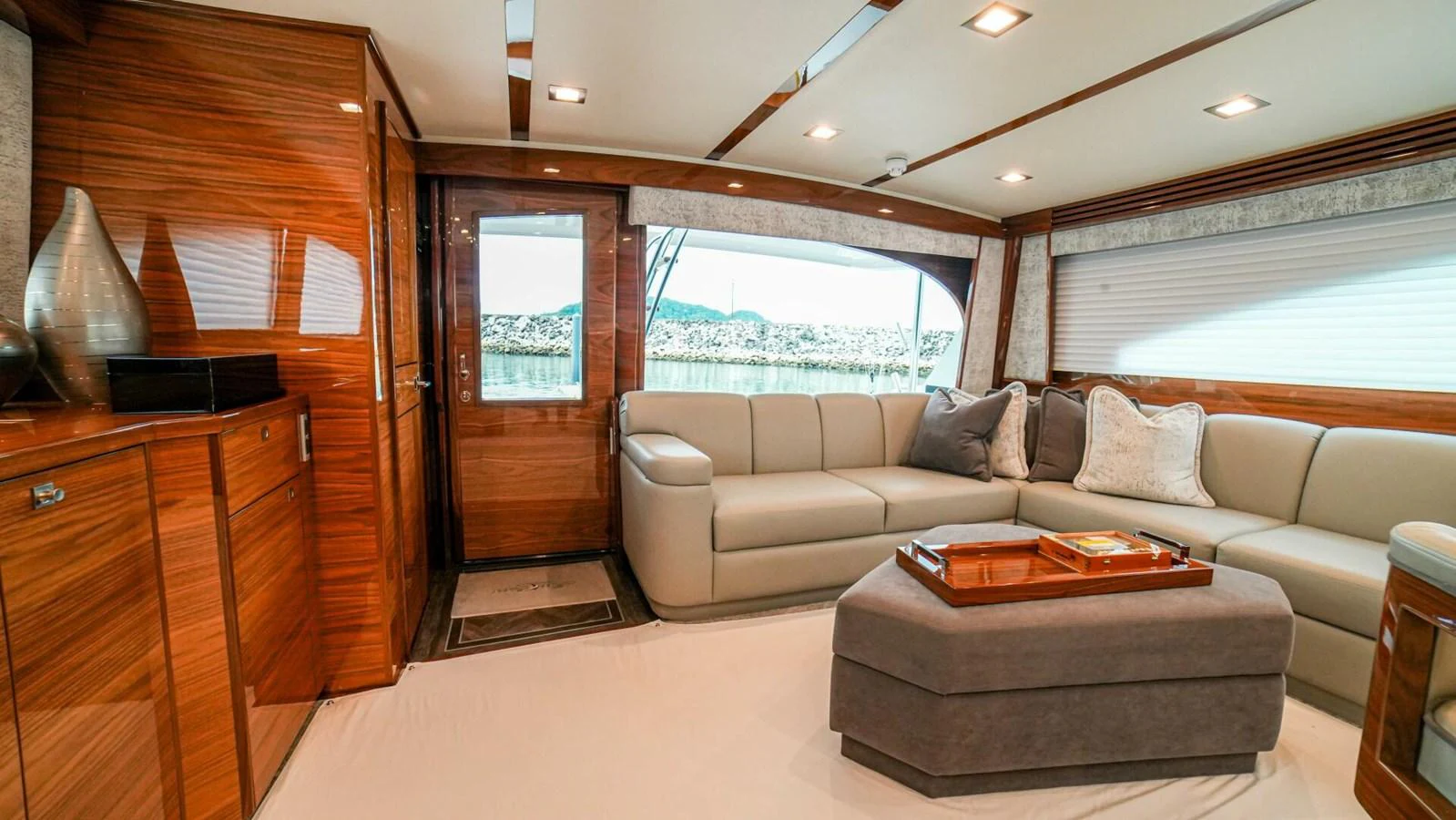 The salon features luxurious seating with elegant wood finishes and ample natural light. aboard FREE SPOOL Yacht for Sale