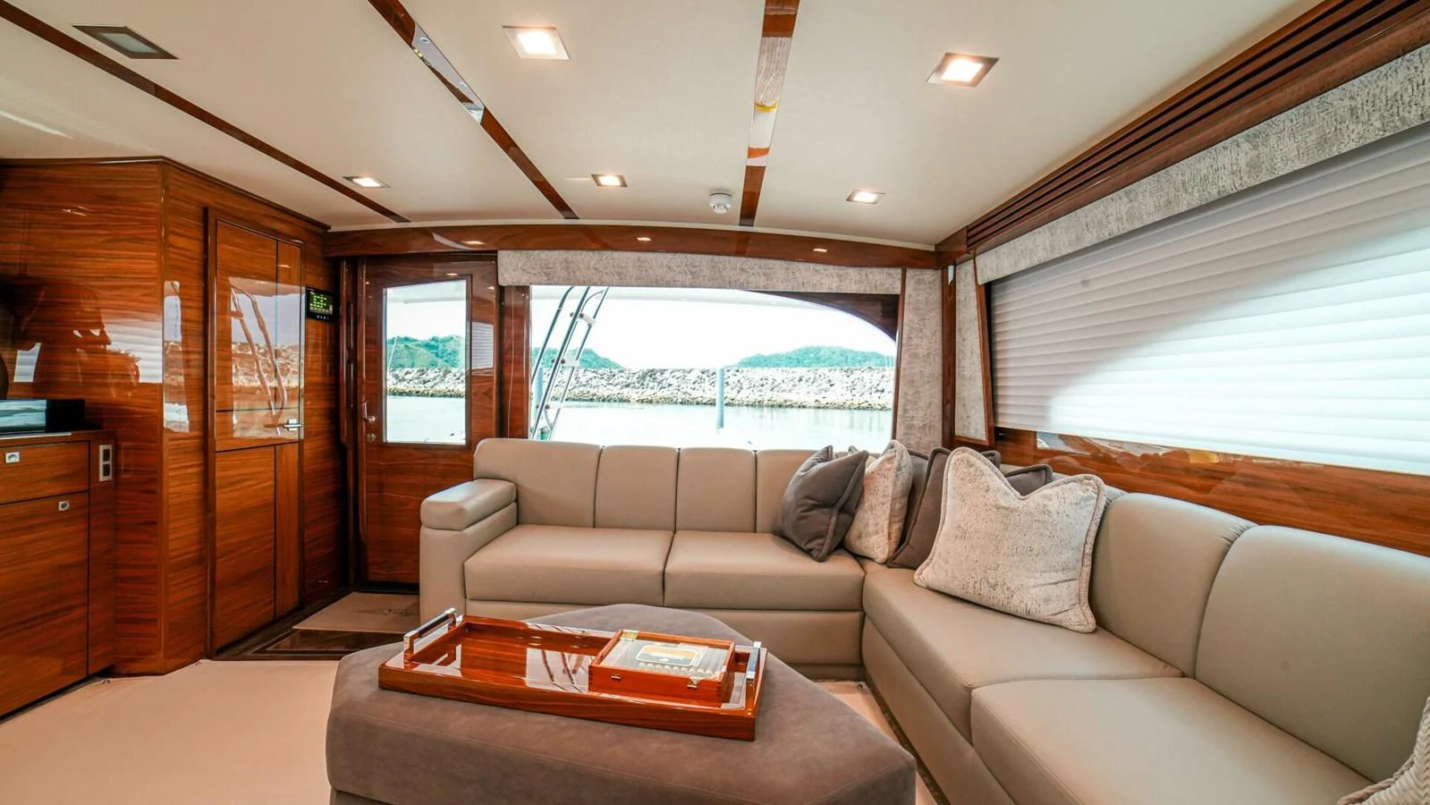 The salon features luxurious seating with elegant wood finishes and ample natural light. aboard FREE SPOOL Yacht for Sale