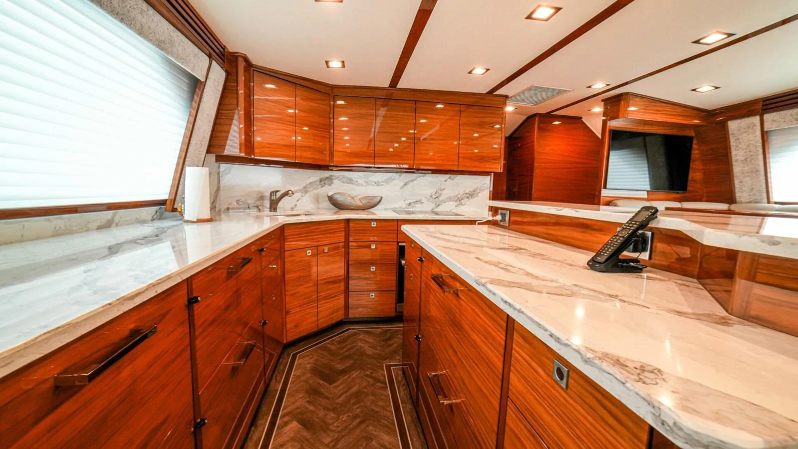 The yacht's galley features elegant wood cabinetry and marble countertops. aboard FREE SPOOL Yacht for Sale