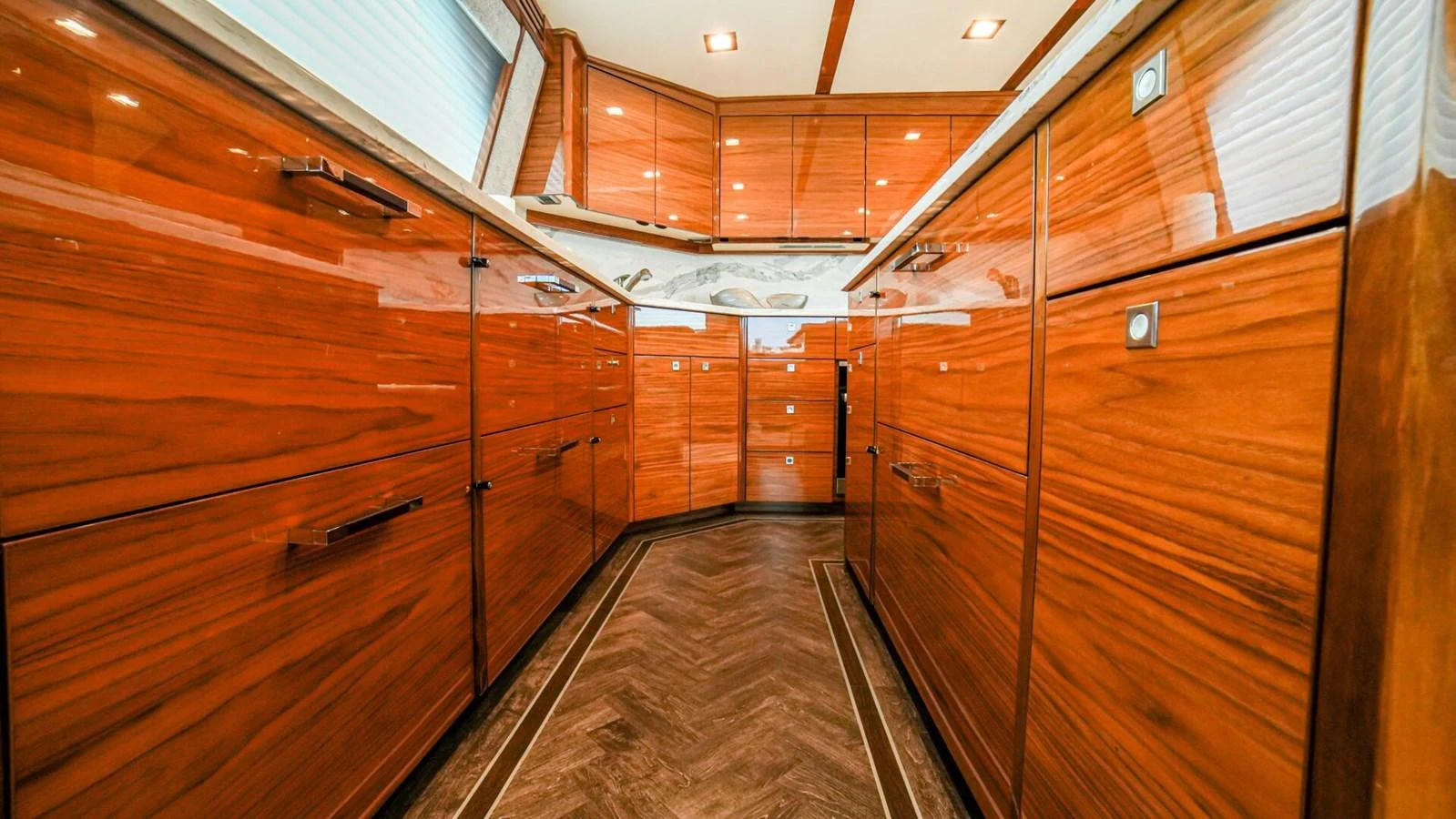 The yacht's galley features rich wood cabinetry and modern fixtures. aboard FREE SPOOL Yacht for Sale