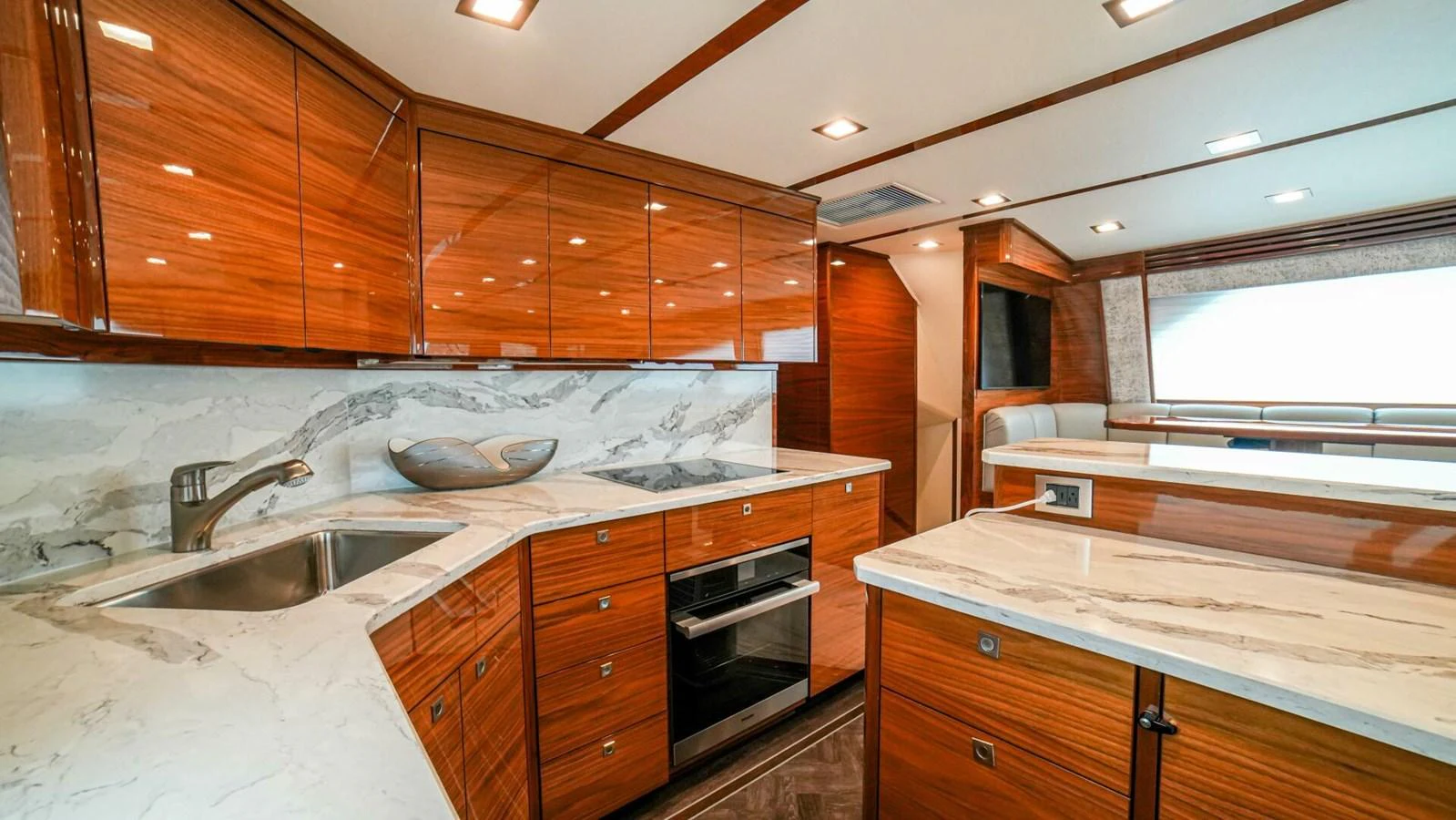The yacht's galley features sleek wooden cabinetry and modern appliances, creating a sophisticated and functional space. aboard FREE SPOOL Yacht for Sale
