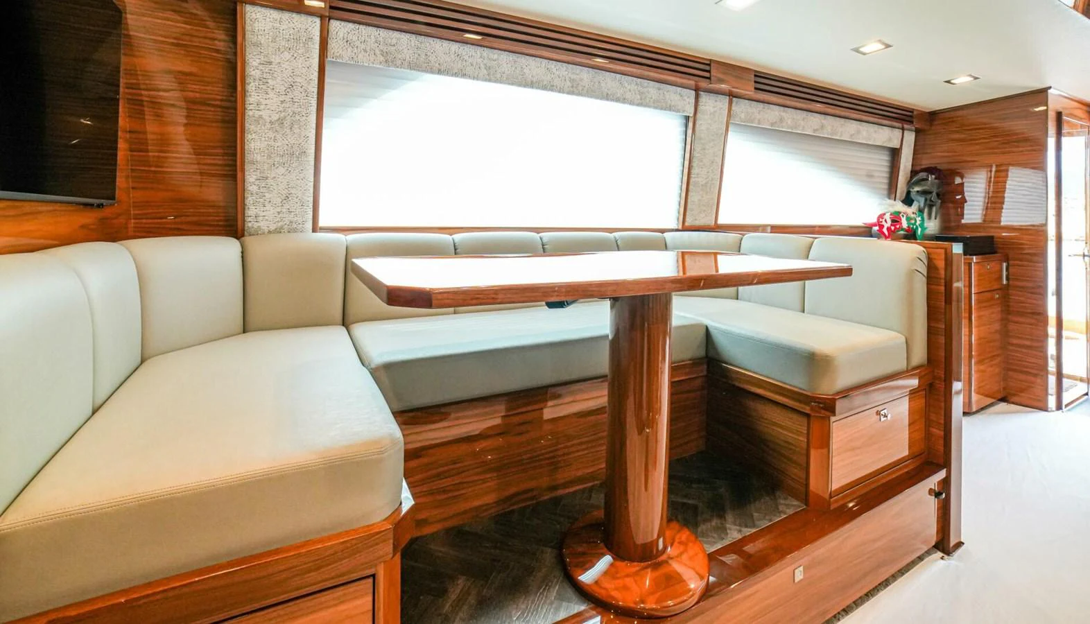 The salon features elegant wood finishes and comfortable seating with a central table. aboard FREE SPOOL Yacht for Sale