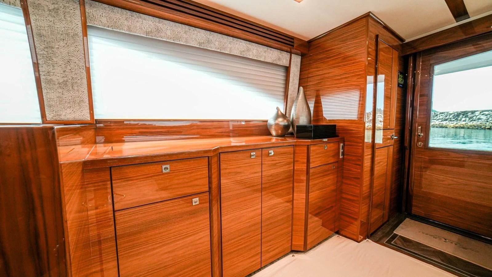 The yacht's interior features elegant wooden cabinetry and modern decor. aboard FREE SPOOL Yacht for Sale