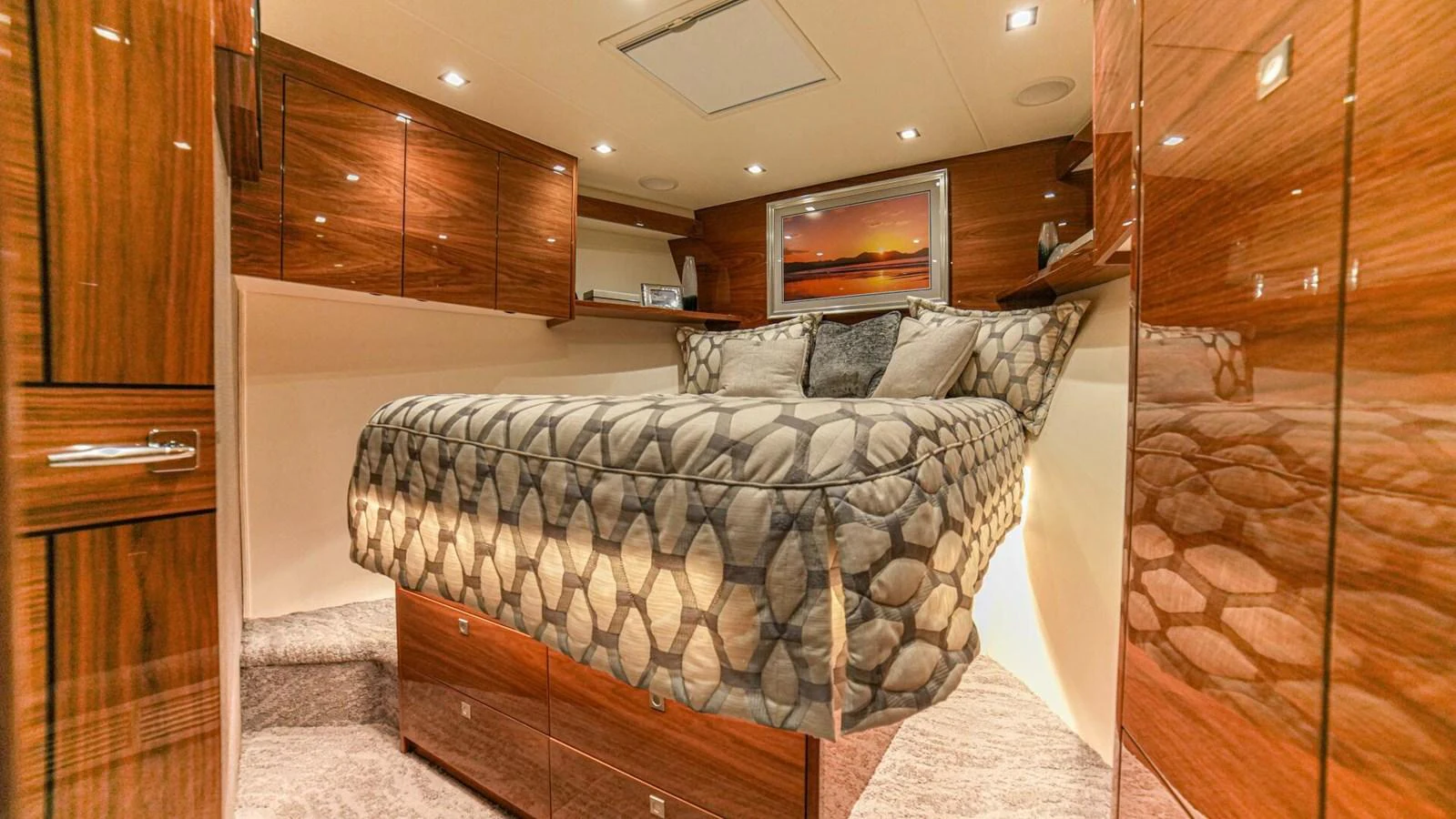 A cozy stateroom featuring a comfortable bed and elegant wooden cabinetry. aboard FREE SPOOL Yacht for Sale