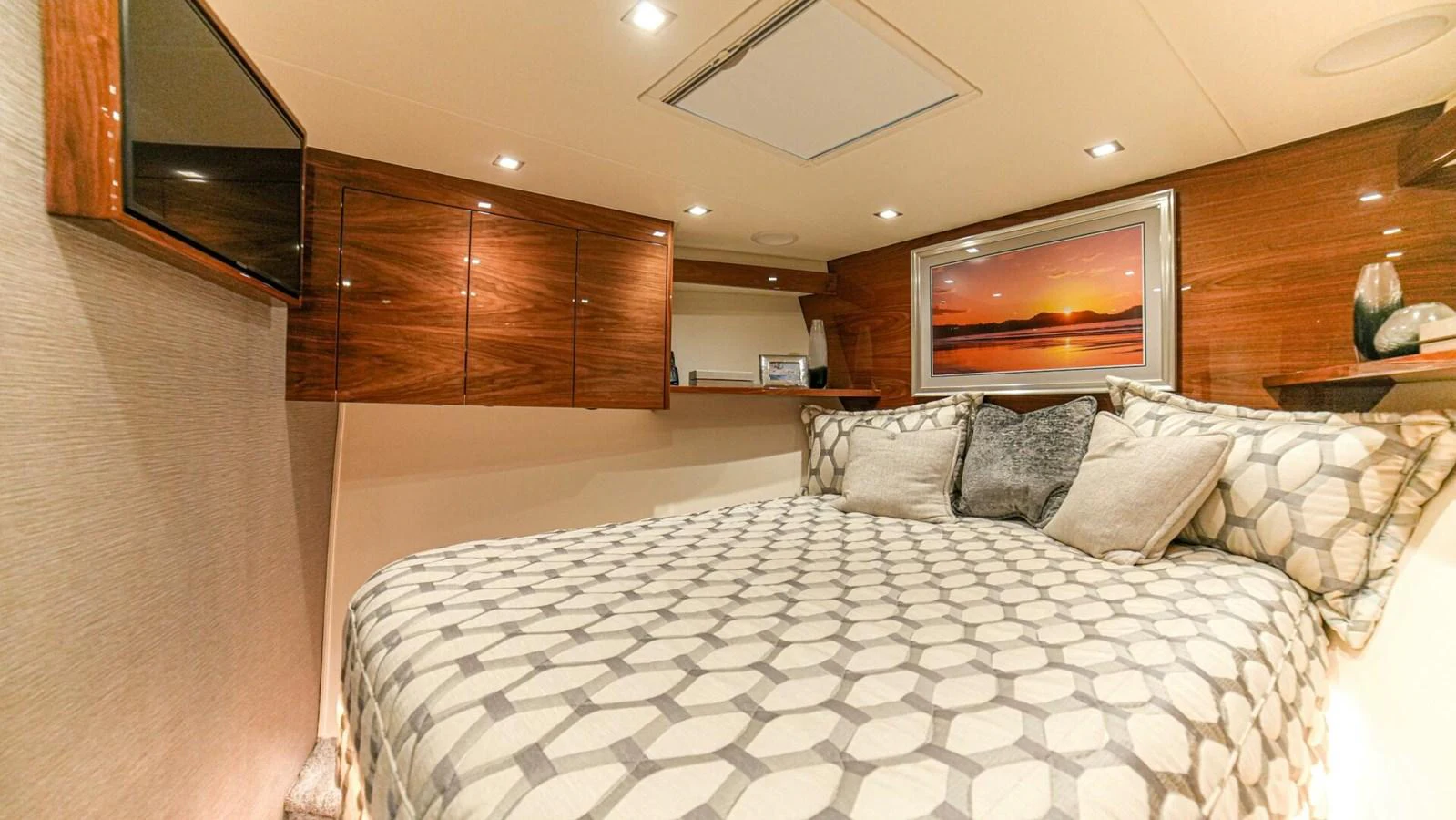 A cozy stateroom featuring a comfortable bed and elegant wood paneling. aboard FREE SPOOL Yacht for Sale