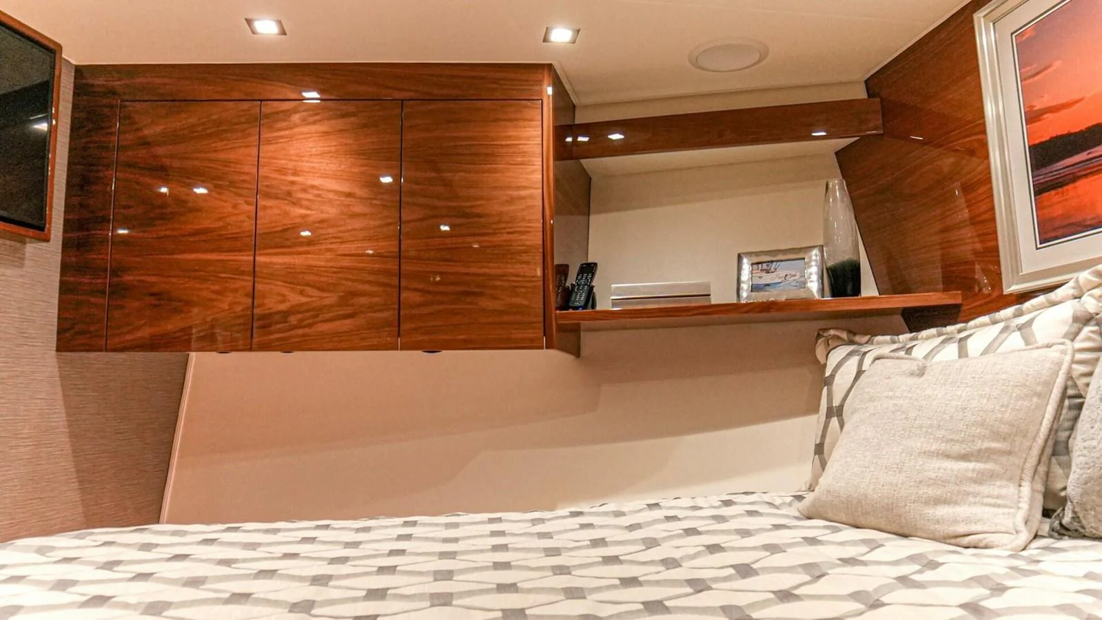A cozy stateroom with elegant wood cabinetry and a comfortable bed. aboard FREE SPOOL Yacht for Sale