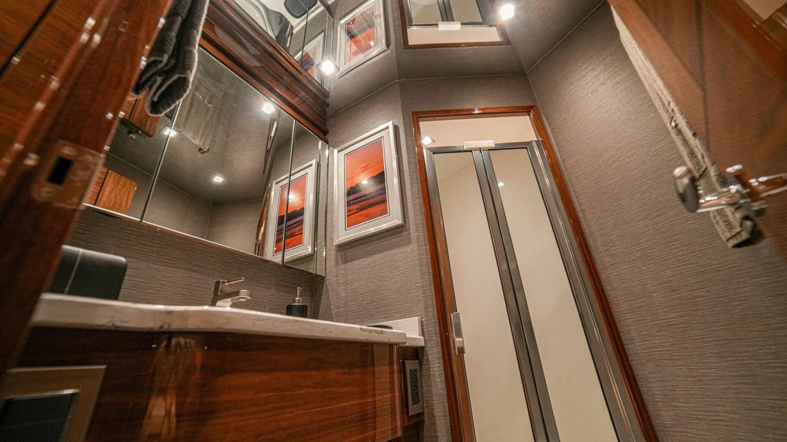 The yacht's bathroom features elegant wood finishes and modern fixtures. aboard FREE SPOOL Yacht for Sale