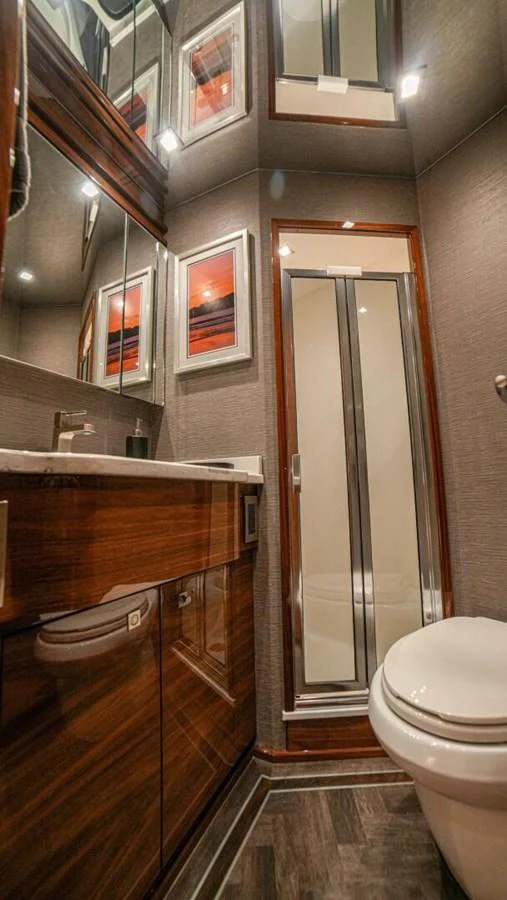 A luxurious bathroom with modern fixtures and elegant wood accents. aboard FREE SPOOL Yacht for Sale