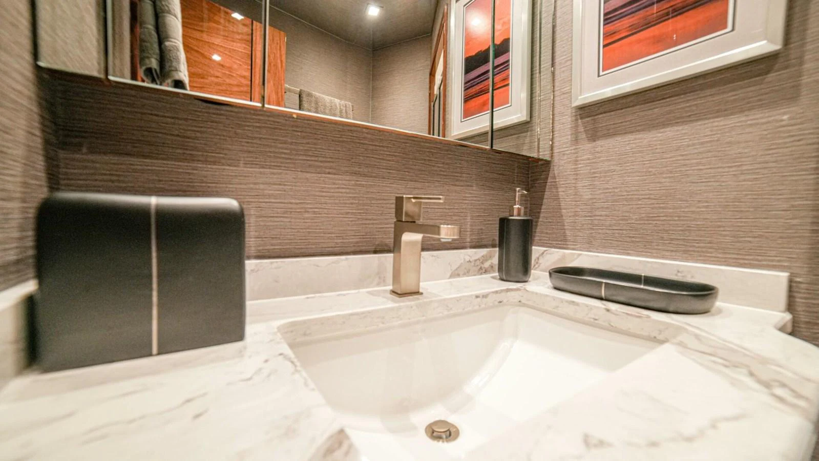 A modern yacht bathroom featuring a sleek sink and stylish decor. aboard FREE SPOOL Yacht for Sale
