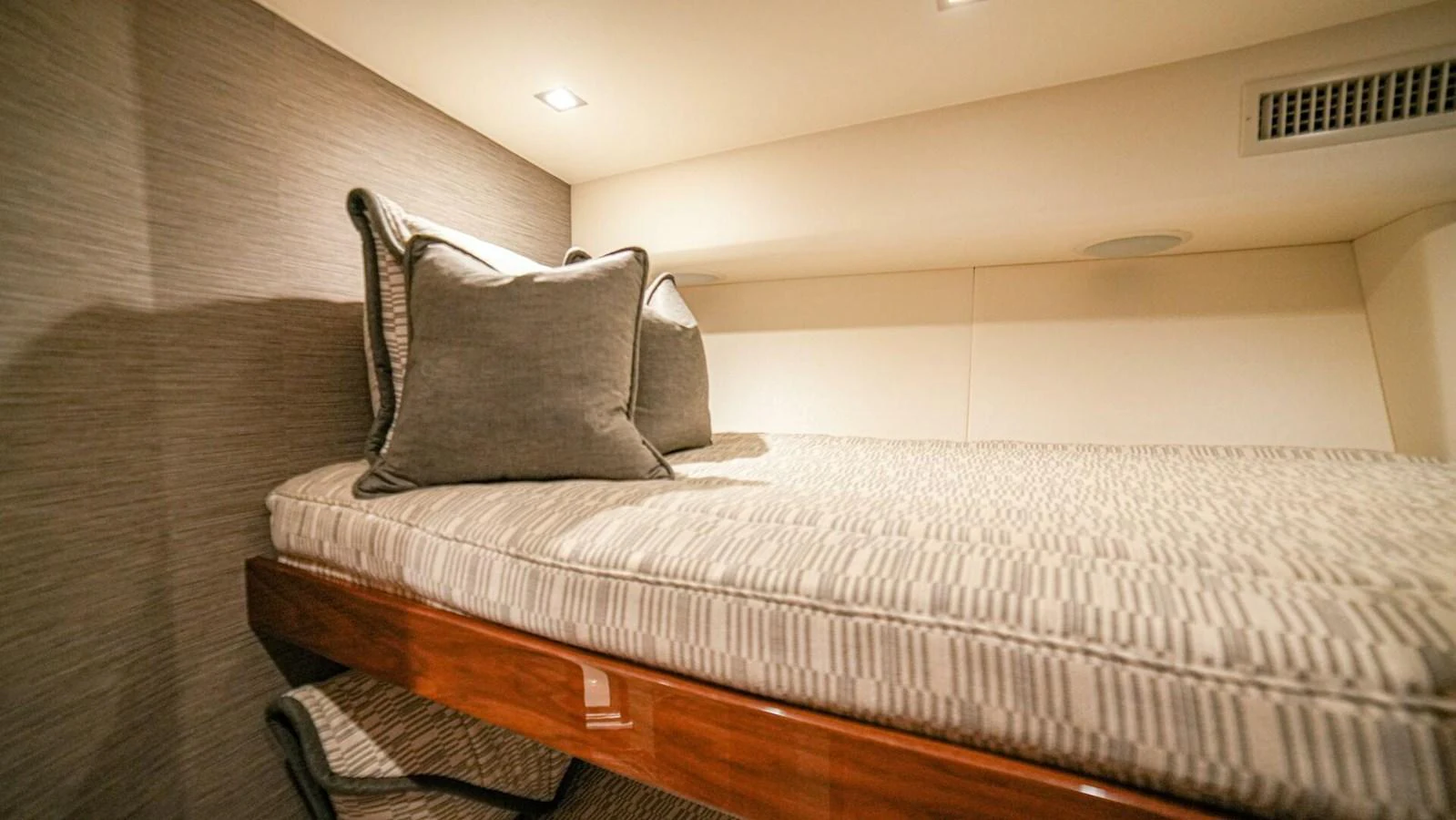 A cozy guest cabin featuring a neatly made bed with plush pillows. aboard FREE SPOOL Yacht for Sale