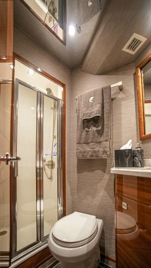 A well-appointed yacht bathroom featuring modern fixtures and elegant wood accents. aboard FREE SPOOL Yacht for Sale