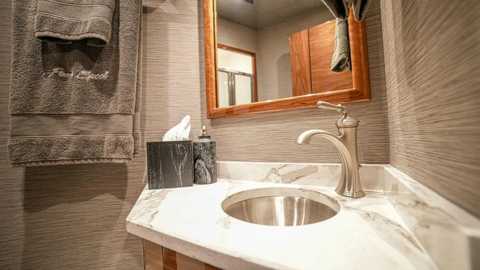 A luxurious yacht bathroom featuring elegant fixtures and marble countertops. aboard FREE SPOOL Yacht for Sale