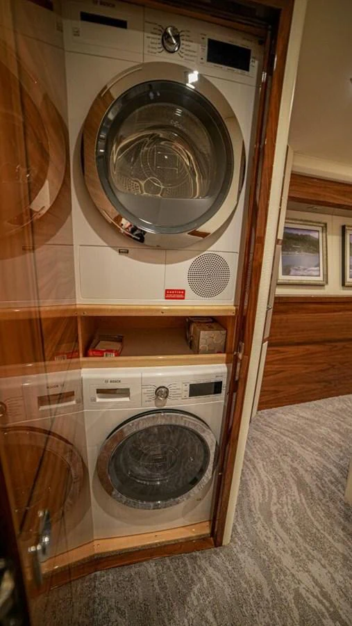 The yacht features a convenient laundry area with modern appliances. aboard FREE SPOOL Yacht for Sale