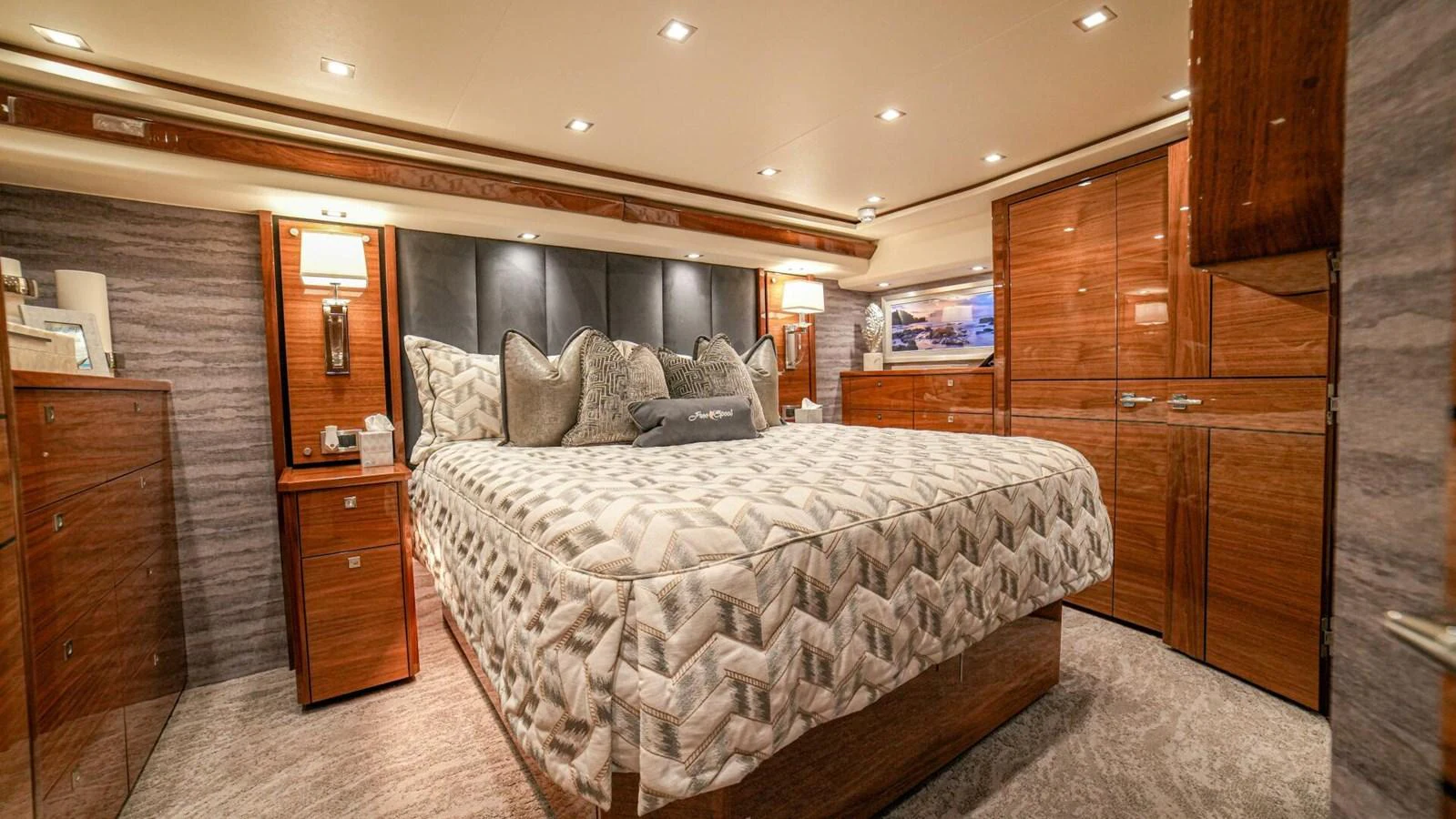 The master stateroom features elegant wood cabinetry and luxurious bedding. aboard FREE SPOOL Yacht for Sale