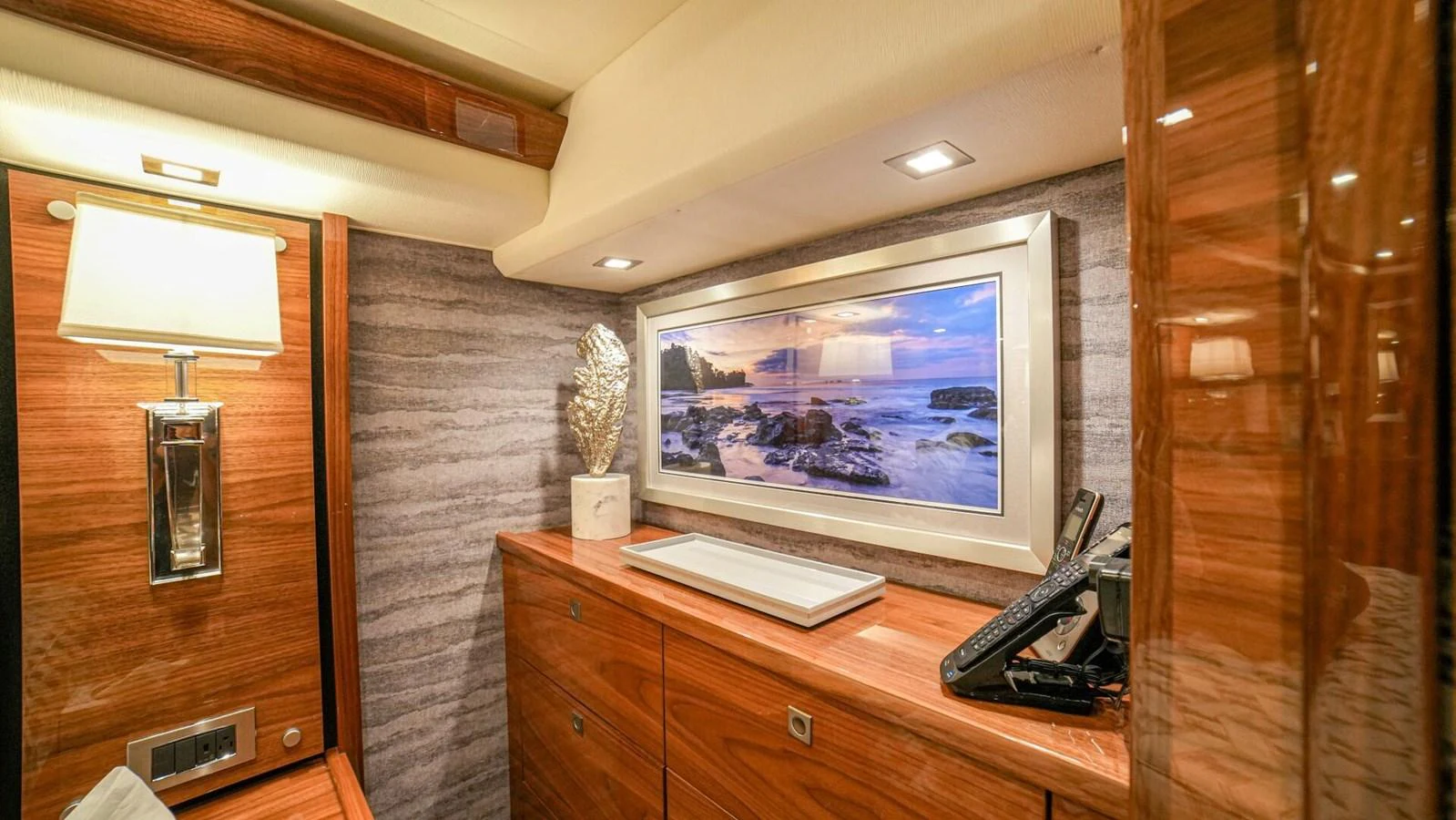 The yacht's interior features elegant wooden cabinetry and modern lighting. aboard FREE SPOOL Yacht for Sale