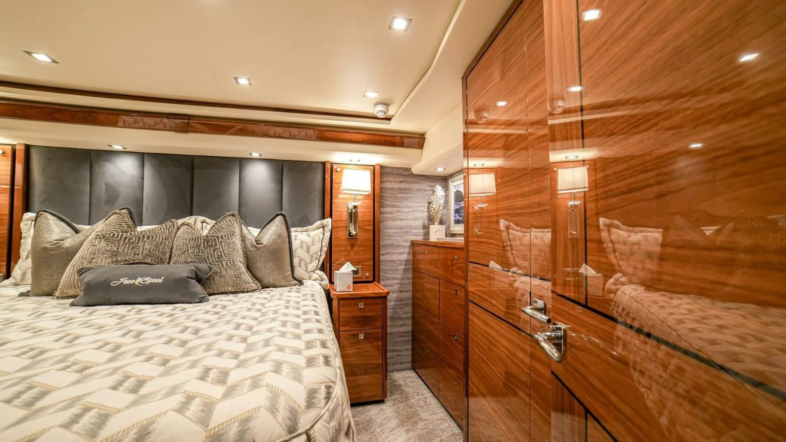 The luxurious stateroom features elegant wood finishes and plush bedding for ultimate comfort. aboard FREE SPOOL Yacht for Sale